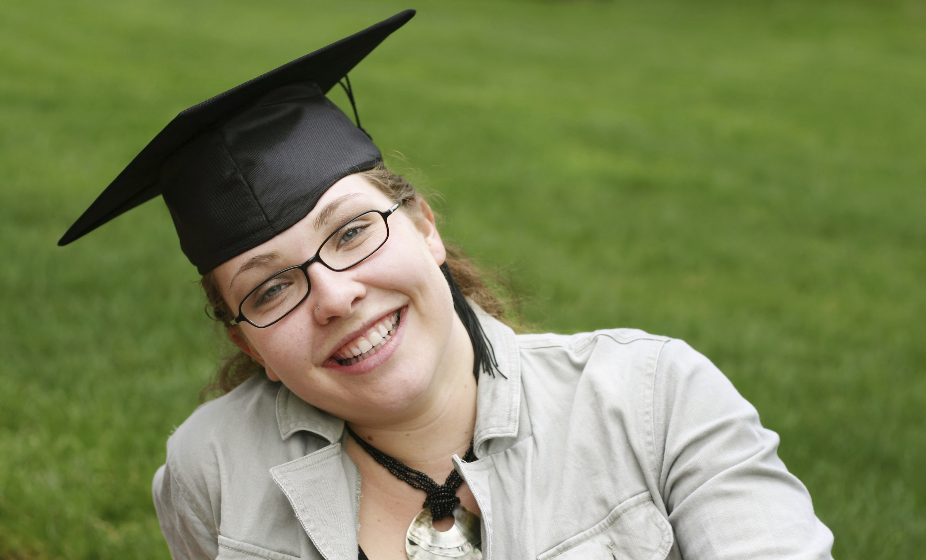 smiling teen girl wearing graduation cap.