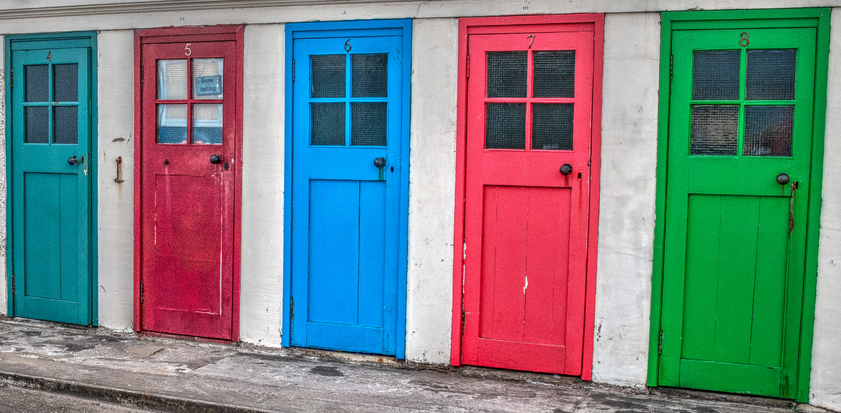 An array of colored doors at Berwick Harbour.