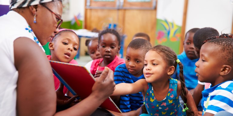 Teacher reads a story to preschool children.