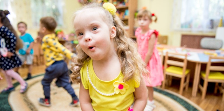 A preschool girl with Down's Syndrome in her inclusive preschool classroom.